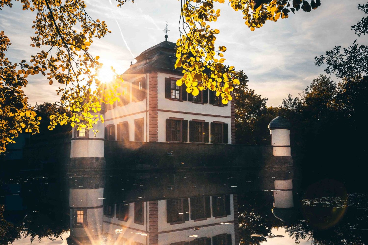 Landscape photo in the sunset, at the lake near Wasserburg moated castle in Seligenstadt, Germany.